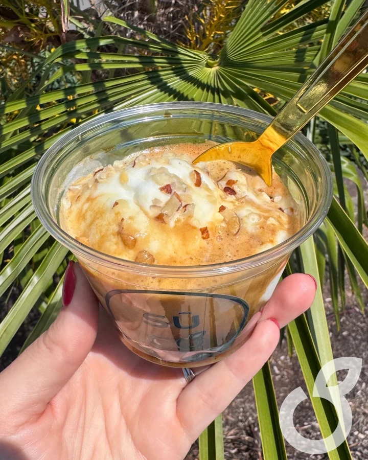 Espresso pours into a glass, then over a scoop of ice cream.